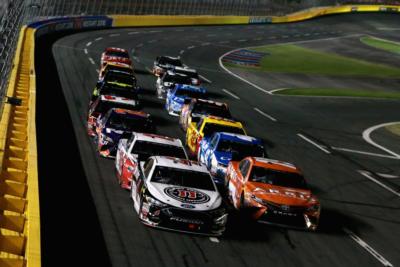 Kevin Harvick, driver of the #4 Jimmy John's Ford, and Daniel Suarez, driver of the #19 ARRIS Toyota, lead the field during the Monster Energy NASCAR Cup Series All-Star Race at Charlotte Motor Speedway.