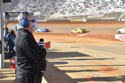 PRN pit reporter Brett McMillan looks on from pit road during the 2021 Food City Dirt Race at Bristol Motor Speedway