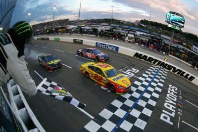 MARTINSVILLE, VA - OCTOBER 28: Joey Logano, driver of the No. 22 Shell Pennzoil Ford, crosses the finish line ahead of Martin Truex Jr., driver of the No. 78 5-hour ENERGY/Bass Pro Shops Toyota, to win the Monster Energy NASCAR Cup Series First Data 500 at Martinsville Speedway on October 28, 2018 in Martinsville, Virginia.
