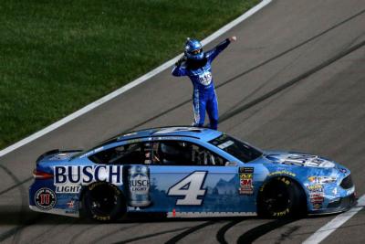 Kevin Harvick, driver of the No. 4 Busch Light Ford, celebrates after winning the KC Masterpiece 400 at Kansas Speedway.