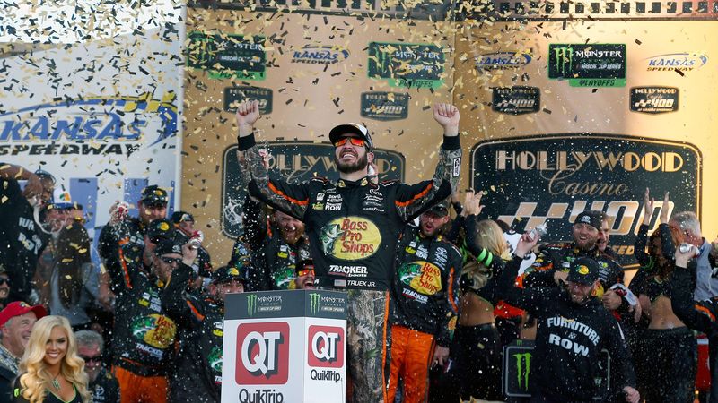 Martin Truex Jr., driver of the #78 Bass Pro Shops/Tracker Boats Toyota, celebrates in Victory Lane after winning the Monster Energy NASCAR Cup Series Hollywood Casino 400 at Kansas Speedway on October 22, 2017 in Kansas City, Kansas.