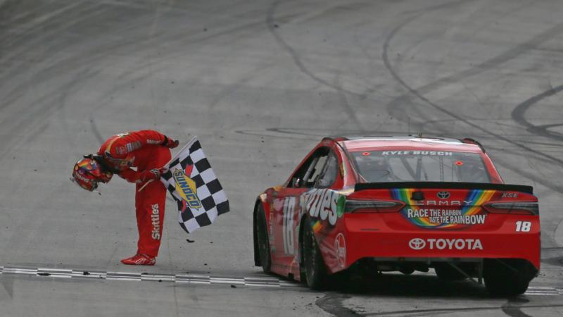 Kyle Busch celebrates with the checkered flag after winning the Food City 500.