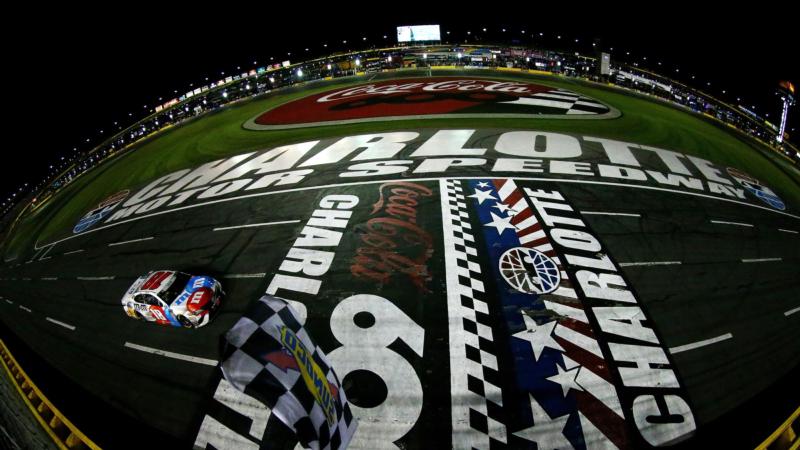 CHARLOTTE, NC: Kyle Busch, driver of the No. 18 M&M's Red White & Blue Toyota, takes the checkered flag to win the Monster Energy NASCAR Cup Series Coca-Cola 600 at Charlotte Motor Speedway on May 27, 2018 in Charlotte, North Carolina.