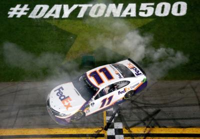 Denny Hamlin celebrates after winning the Monster Energy NASCAR Cup Series 61st Annual Daytona 500 at Daytona International Speedway on February 17, 2019 in Daytona Beach, Florida.