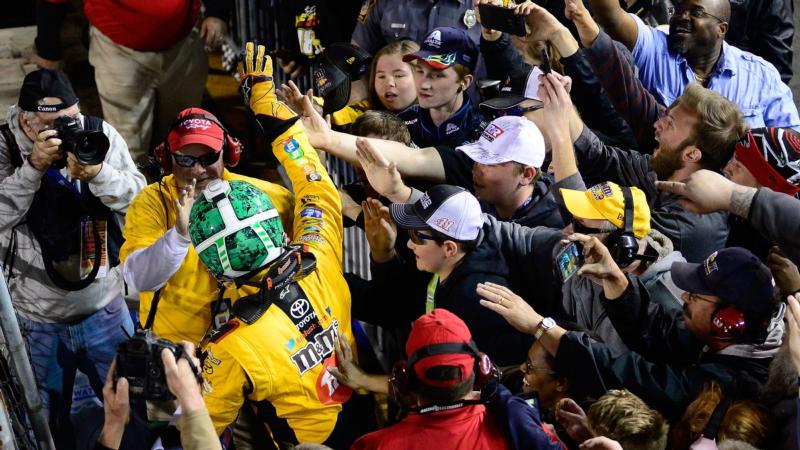 Kyle Busch celebrates with fans on the front stretch after winning the Toyota Owners 400 at Richmond Raceway.