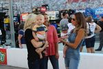 Samantha Busch and Katelyn Sweet have a moment with their sons on the gird before the Xfinity race at Bristol Motor Speedway.
