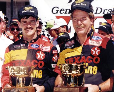 Davey Allison (L) with car owner Robert Yates in Michigan victory lane after the 1991 Miller Genuine Draft 400.
